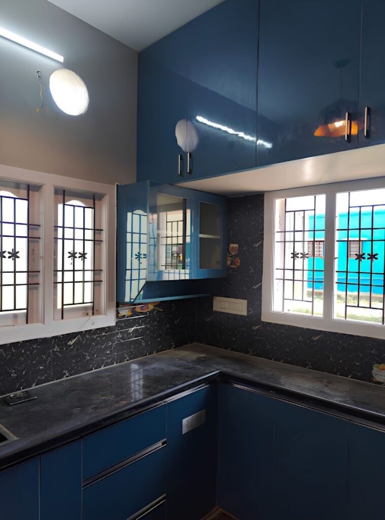 Modular kitchen with blue cabinets and dark granite counter, House Decors, Chennai