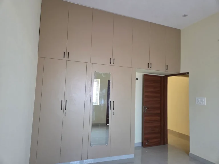 Beige floor-to-ceiling wardrobe with loft in a rental flat, Kodambakkam