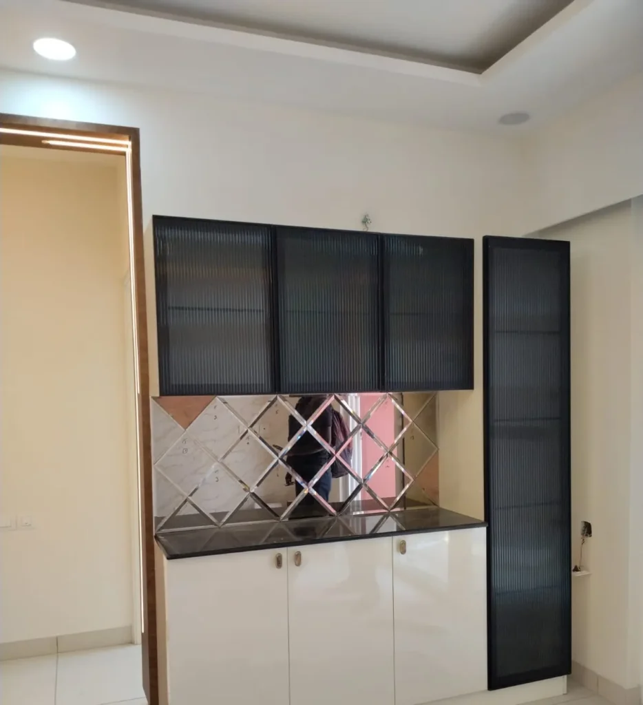 Crockery unit with black fluted-glass wall cabinets, a diamond-pattern mirror backsplash and cream gloss base doors, House Decors, Chennai