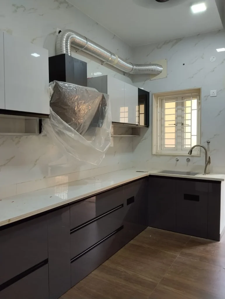 L-shaped kitchen with dark grey base drawers, white countertop, marble-look wall tiles and wall cabinets, House Decors, Chennai