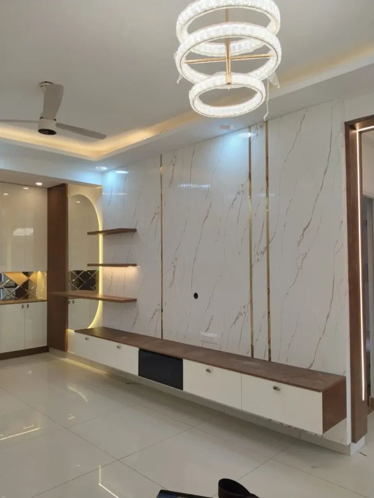 TV wall with marble-look panels and gold strips, a floating TV unit and an arched niche with shelves, House Decors, Chennai